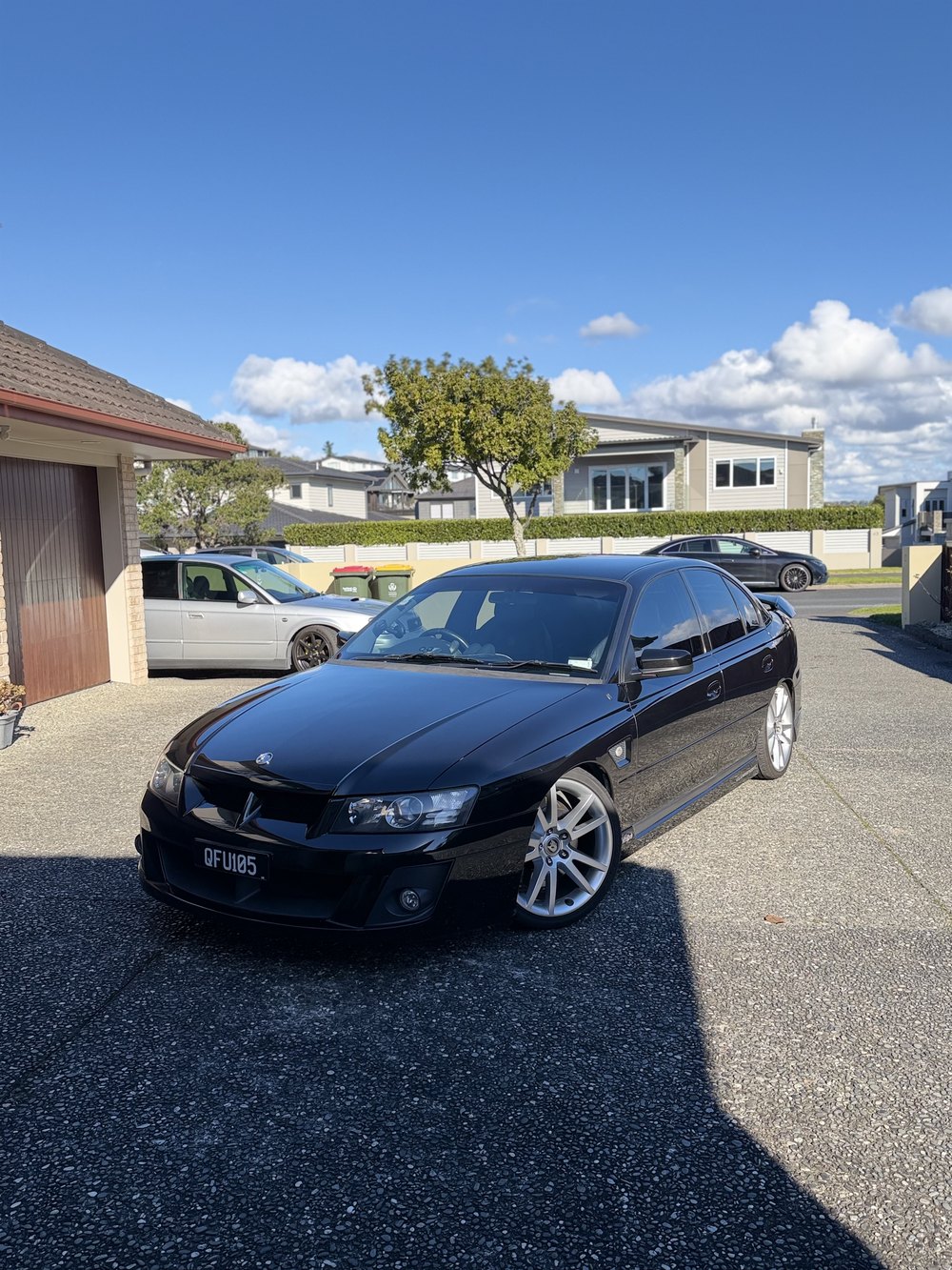 Black Holden Commodore, front three-quarter view, detailed